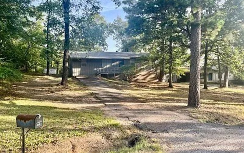 Front exterior with mailbox and gravel driveway