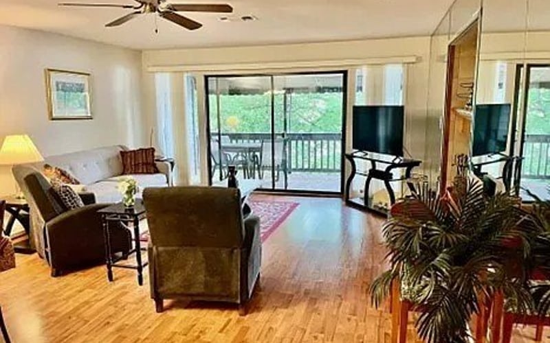 Living room with hardwood floors and deck access