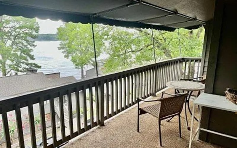 Covered deck with lake view and seating
