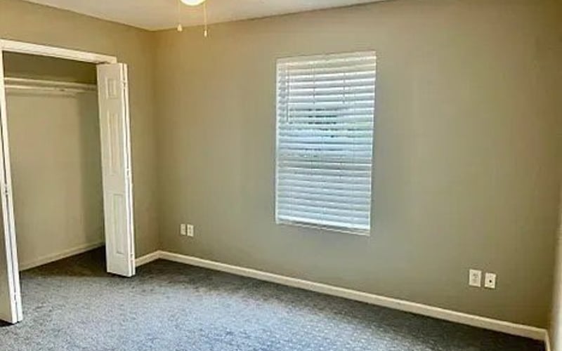 Second bedroom with carpet and closet