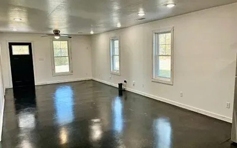 Open living area with dark stained concrete floors