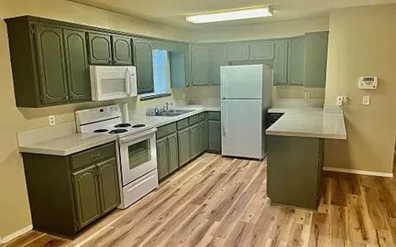 Kitchen with green cabinets and hardwood floors