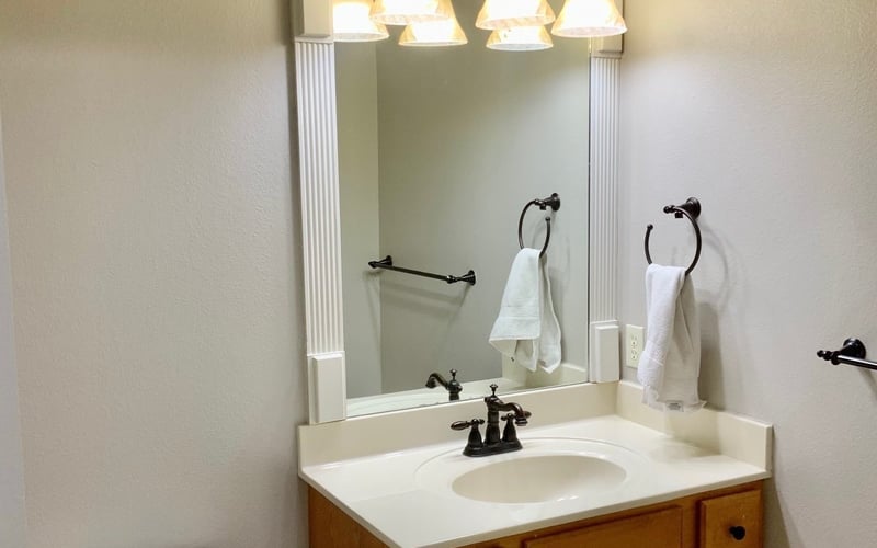 Bathroom vanity with ornate mirror and vanity lights