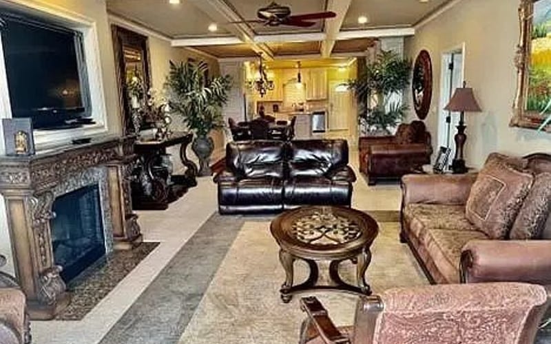 Living room full layout with fireplace and kitchen view