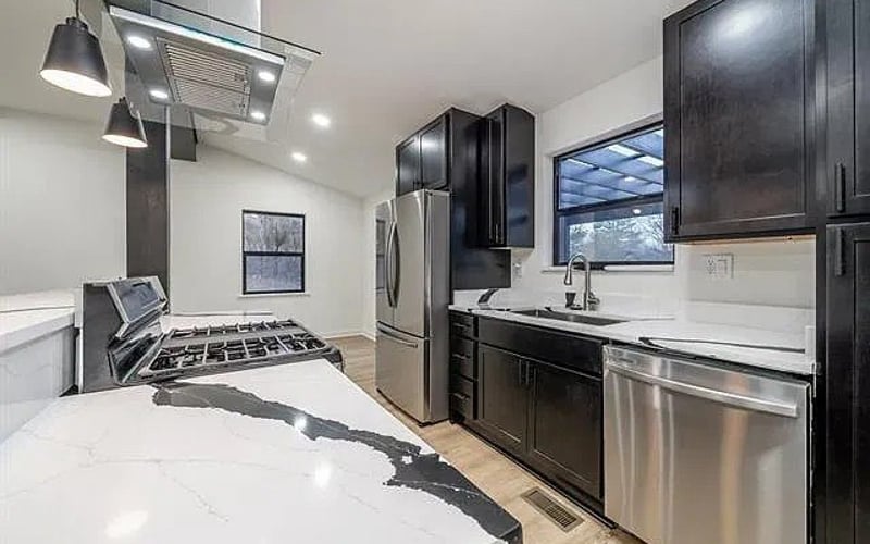 Kitchen with stainless appliances and marble countertops