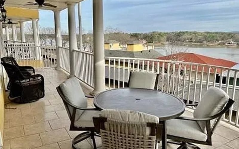 Large balcony with lake view and dining table