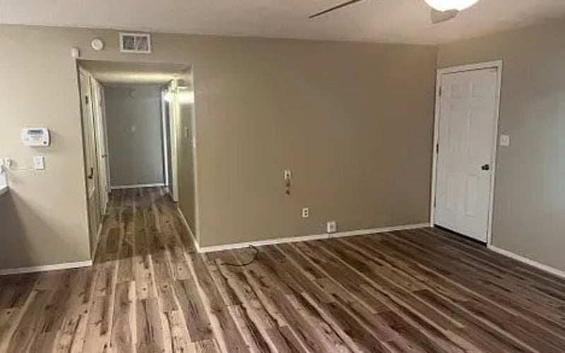 Living area with hardwood floors and hallway