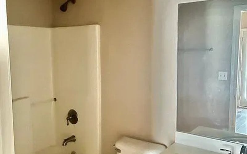 Bathroom with tub/shower combo and wood vanity