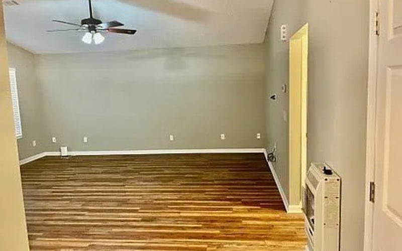 Living room with vaulted ceiling and hardwood floors