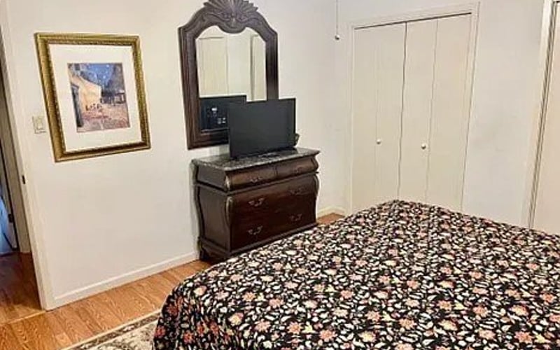 Bedroom dresser with TV and closet