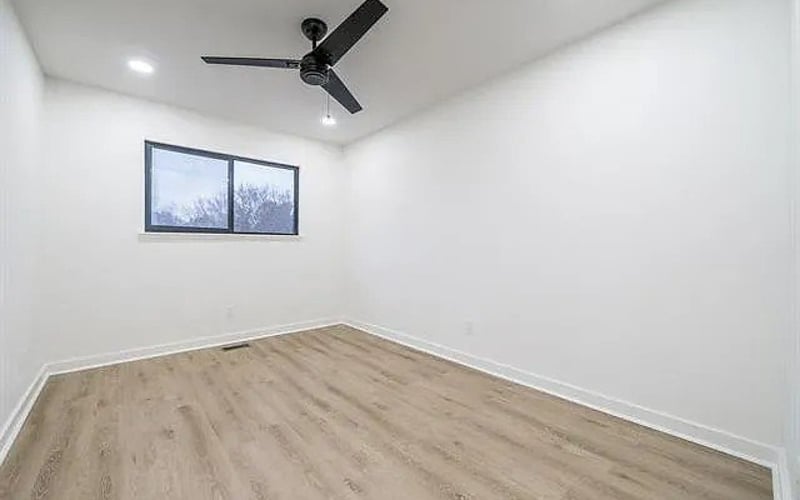Bedroom with ceiling fan and hardwood floors
