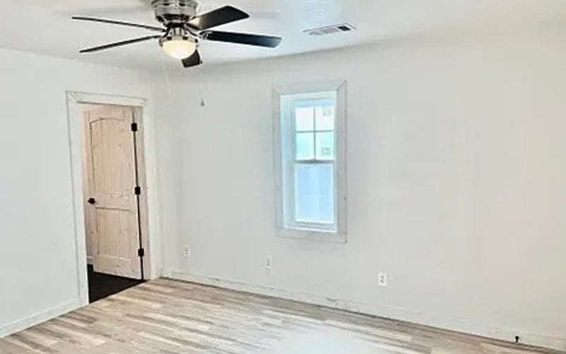 Bedroom with ceiling fan and hardwood floors